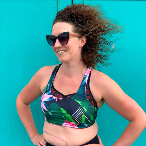 Becky Hughes, Personal Trainer, Smiling in Sunglasses with hair blown backwards
