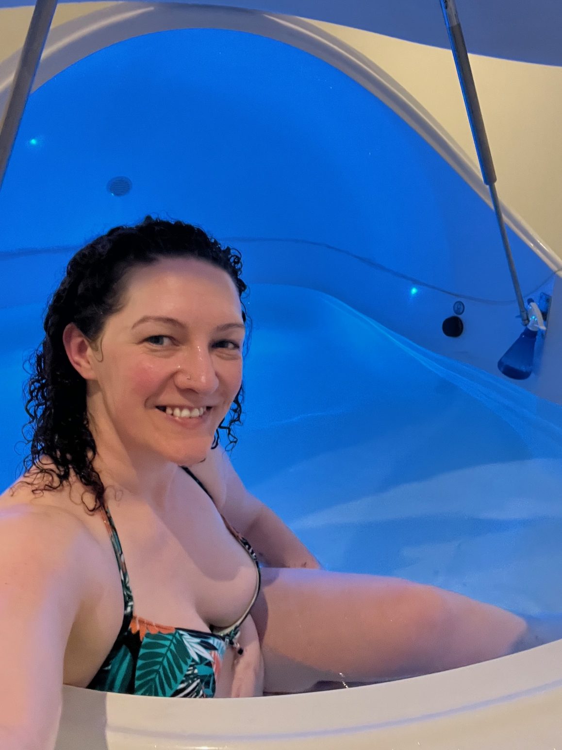 Becky Hughes sits smiling in a float spa in Hove