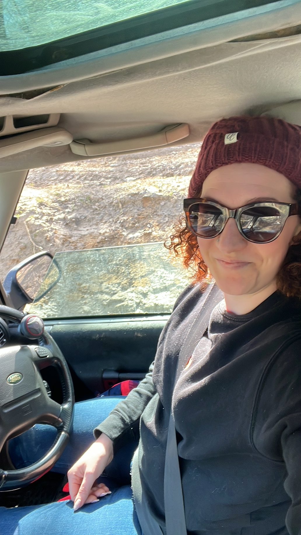 Becky Hughes wearing sunglasses in a Land Rover