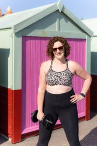 Becky Hughes, Personal Trainer, holding a dumbbell for weight training.